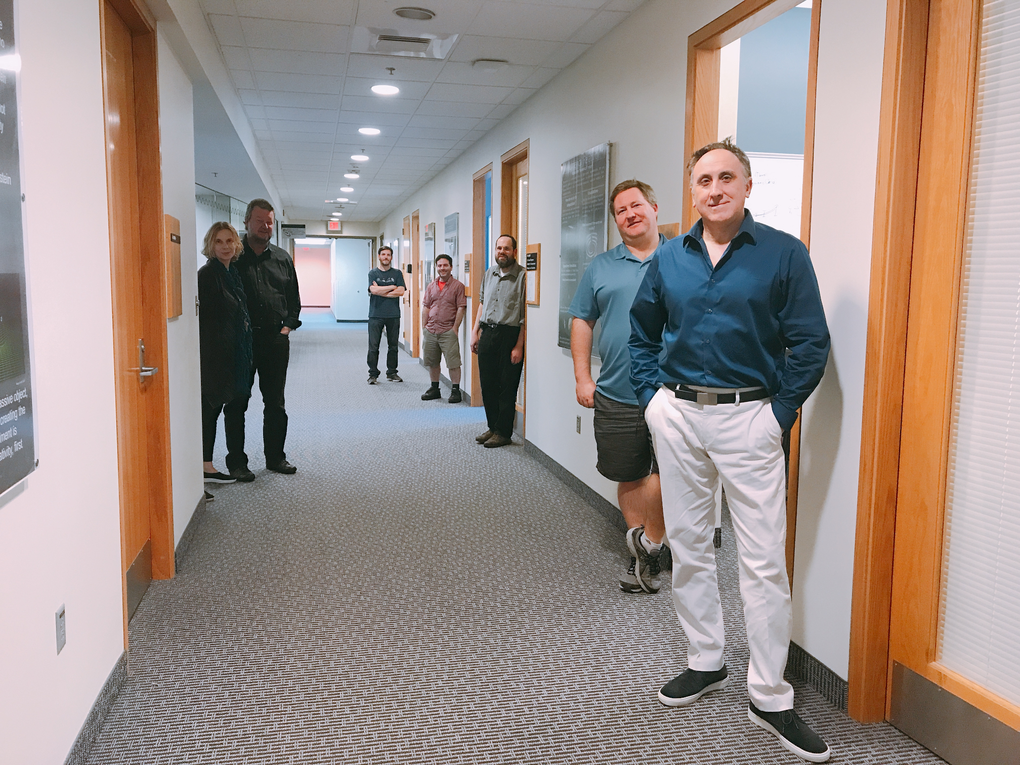 Main hallway of the CCRG, with faculty standing by their offices (right) and some faculty with offices elsewhere (left).